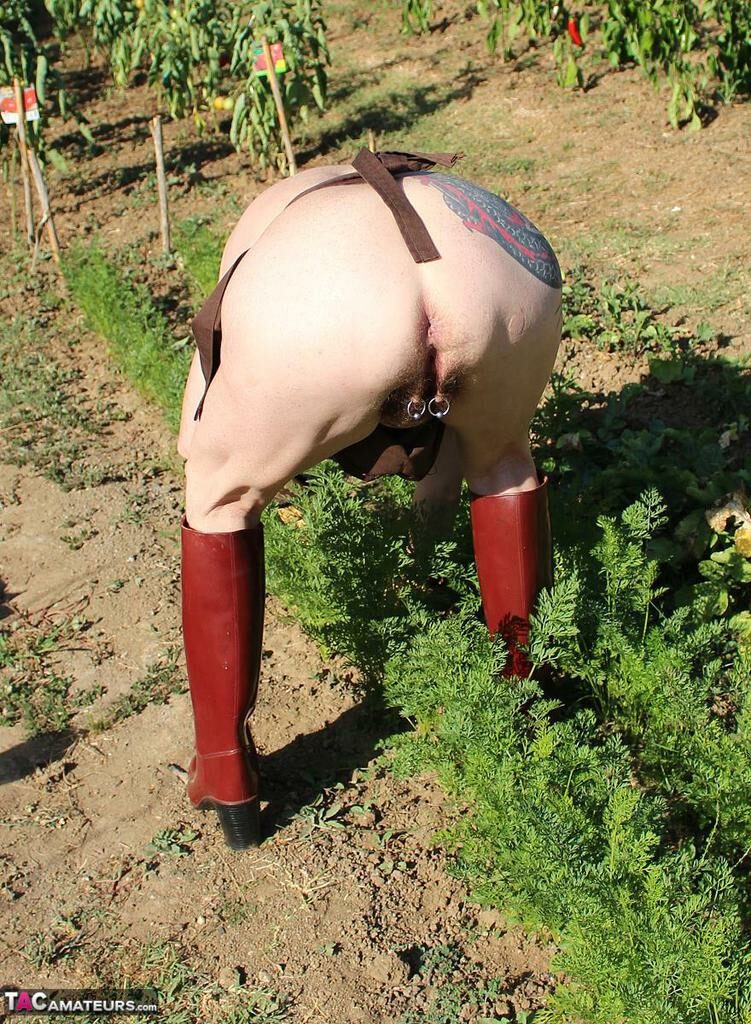 Filthy old woman gardening wearing just an apron bends over and shows her hairy cunt